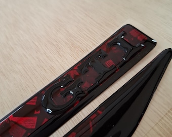 2 x GTI wing emblems - Black base w/ Red forged carbon