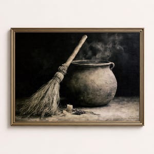 May include: A framed oil painting depicting a dark, round, textured cauldron with wisps of smoke rising from the top. A straw broom leans against the side of the pot, and a small candle sits on the surface next to a sprig of dried herbs.