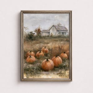 May include: An oil painting in a metallic frame depicting a field of orange pumpkins in the foreground with a white farmhouse in the background under a cloudy sky. The artwork features visible brushstrokes and a signature in the bottom right corner.