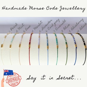 May include: Ten colourful bracelets with gold beads and a white background. The bracelets are labelled with numbers and colour names, such as "1. Pearl", "2. Mint", "3. Rose", "4. Merlot", "5. Lavender", "6. Earl Grey", "7. Emerald", "8. Olive", "9. Blueberry", and "10. Black". The text "Handmade Morse Code Jewellery" is at the top of the image. The text "Say it in secret..." is at the bottom of the image.