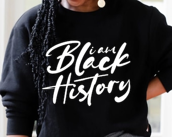 May include: A black sweatshirt with the text "i am Black History" in white lettering.