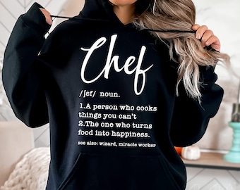 May include: Black hooded sweatshirt with white text that reads "Chef /Jef/ noun. 1.A person who cooks things you can't 2. The one who turns food into happiness. see also: wizard, miracle worker"