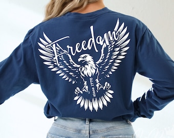 May include: A navy blue long-sleeve shirt with a white eagle graphic and the text "Freedom since 1776".