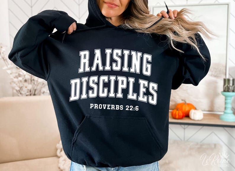 May include: Black hooded sweatshirt with white text that reads "Raising Disciples Proverbs 22:6"
