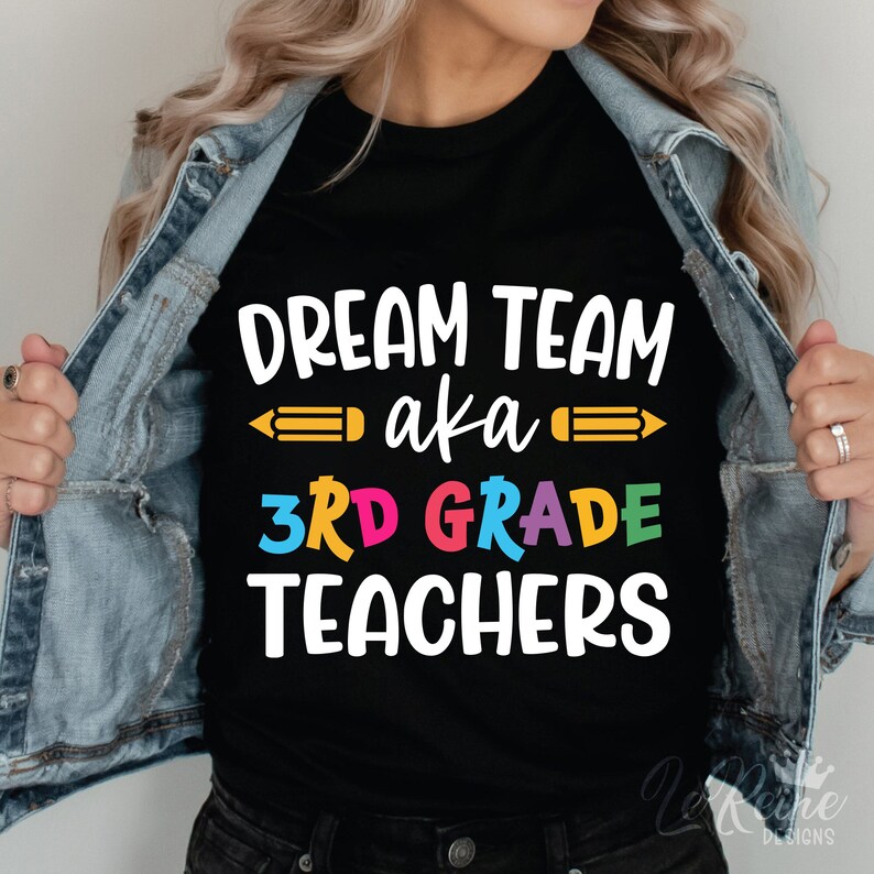 May include: A black t-shirt with the text "Dream Team aka 3rd Grade Teachers" in white. The text "3rd Grade" is in rainbow colors and there are yellow pencils on either side of the text "aka".