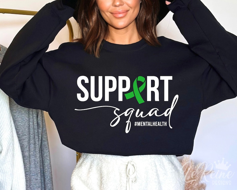 May include: Black sweatshirt with white text that says "SUPPORT squad #MENTALHEALTH" and a green ribbon.