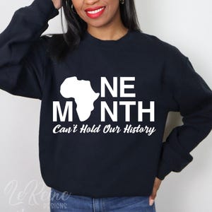 May include: Black sweatshirt with white text that reads "One Month Can't Hold Our History" and a white outline of the continent of Africa.