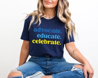 May include: A navy blue t-shirt with the text "advocate. educate. celebrate." in blue, yellow, and white.