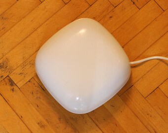 May include: A white, round, ceiling light fixture with a cord.
