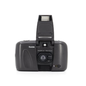 May include: A black Kodak Ektanar lens 35mm camera with a built-in flash. The camera has a zoom lens with a 400 to 100/700 setting.