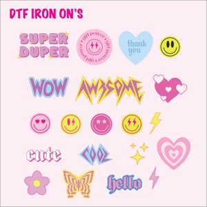 May include: A collection of colorful DTF iron-on transfers with various designs. Includes text like "SUPER DUPER", "WOW", "AWESOME", "cute", "COOL", and "hello". Also features smiley faces, hearts, stars, a butterfly, and lightning bolts.