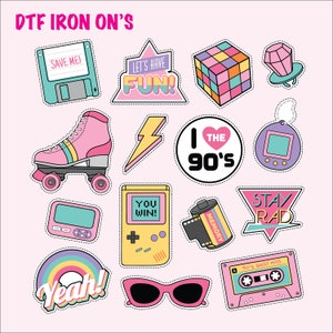 May include: A collection of colorful DTF iron-on patches with a 90s theme. Patches include a roller skate, Rubik's cube, cassette tape, sunglasses, and a handheld game console. The text "DTF IRON ON'S" is at the top.