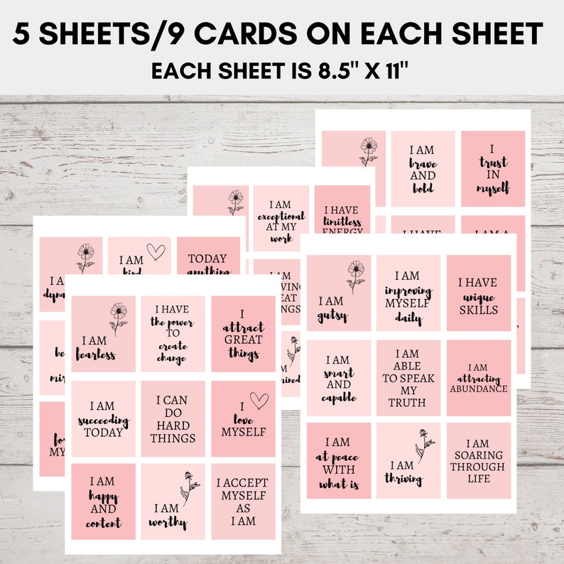 May include: A set of 5 sheets of pink affirmation cards with black text and floral illustrations. Each sheet has 9 cards and measures 8.5 inches by 11 inches. The cards feature positive affirmations such as "I am fearless", "I attract great things", "I am worthy", and "I am thriving".