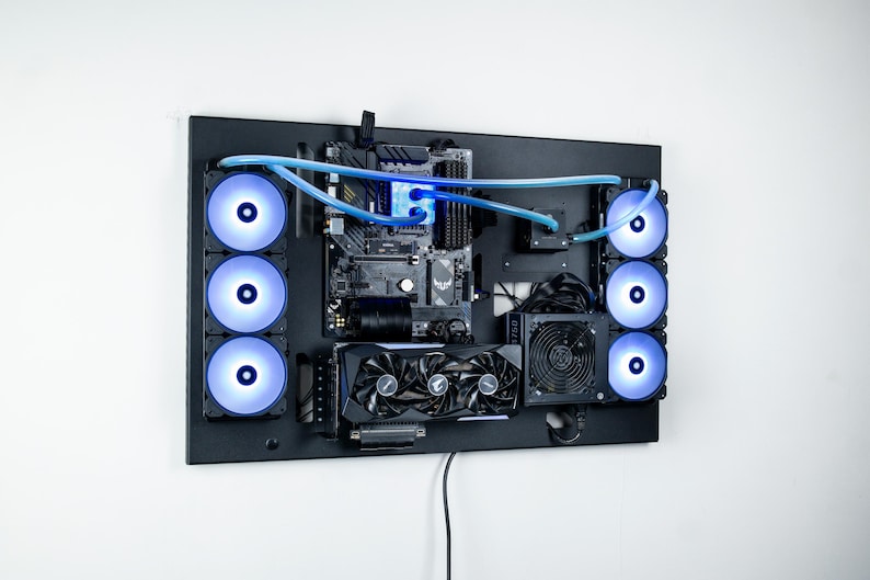 May include: A black computer case with a clear window revealing the motherboard, graphics cards, and fans. The fans are illuminated with blue LEDs. The case is mounted on a wall.