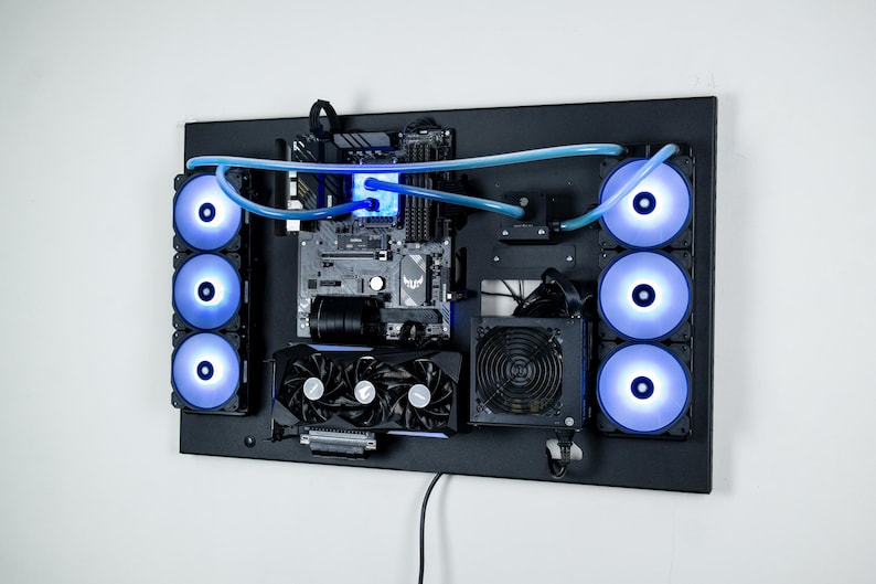 May include: A black computer case with a custom water cooling system. The case has a motherboard, graphics card, and power supply installed. The water cooling system includes a reservoir, pump, and radiator. The case is mounted on a wall.
