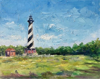 May include: A painting of a black and white striped lighthouse against a blue sky with white clouds. The lighthouse is in front of a green field and trees.
