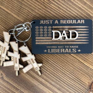 FAST SHIPPING! White elephant gift, Funny Christmas keychain, just a regular "mom/dad/grandpa" trying not to raise liberals. Funny gag gift