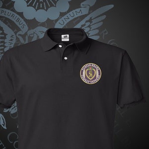 May include: Black polo shirt with a purple embroidered patch that says "Purple Heart Combat Veteran".