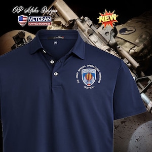 May include: A navy blue polo shirt with a U.S. Army Special Operations Command Airborne patch embroidered on the left chest. The patch features a shield with a winged eagle, a red and yellow flame, and the words "Airborne" and "Central".