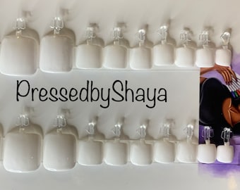 May include: A set of 20 white square-shaped press-on toenails with clear adhesive tabs. The toenails are arranged in two rows on a white card with the text "PressedbyShaya" printed in black.