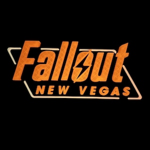 May include: The Fallout: New Vegas logo, in orange, is set against a black background. The text is outlined in white, with the words "Fallout" and "New Vegas" prominently displayed. A lightning bolt graphic is integrated into the design.
