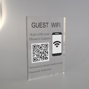 May include: Clear acrylic sign with the words "GUEST WIFI" and instructions to scan with a phone's camera. Includes a QR code and a graphic of a smartphone with a Wi-Fi symbol. The sign also displays the network name and password.
