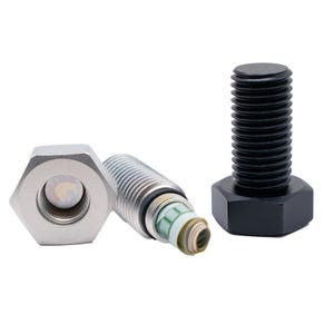 May include: Three metal bolts and a nut are shown against a white backdrop. One bolt is black, the other is silver, and the nut is also silver. The silver bolt has a roll of paper inside. The objects are arranged to showcase their features.