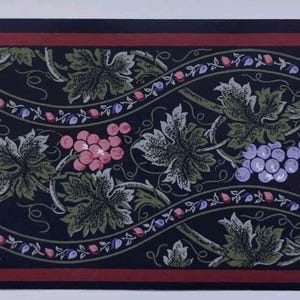 May include: Wallpaper border featuring a repeating pattern of grape clusters and leaves in shades of purple, pink, and green against a dark blue background. The design includes a wavy vine motif with a red border.
