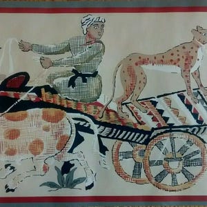 May include: An illustrated tapestry depicts a cheetah on a cart pulled by a spotted ox, driven by a person in a turban. The cart has patterned details, and the scene is set against a beige background with a red border.