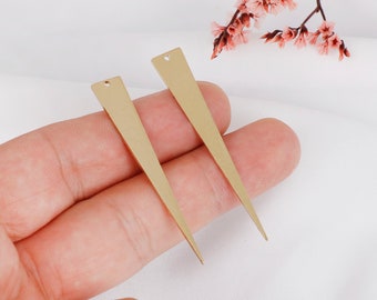 May include: Two gold-colored metal triangle-shaped earring blanks with a hole at the top.