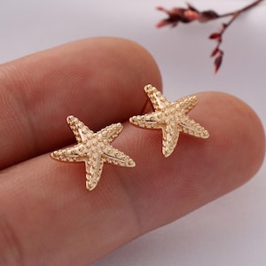 May include: A pair of gold-tone starfish stud earrings. The earrings are small and delicate, and they would make a great gift for someone who loves the sea.