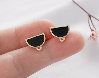 May include: Two gold-toned half-circle charms with black enamel. Each charm has a small loop at the bottom.