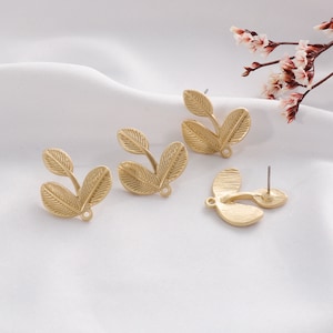 May include: Three gold-tone leaf-shaped earring blanks. The blanks are designed to be used with a variety of earring findings.