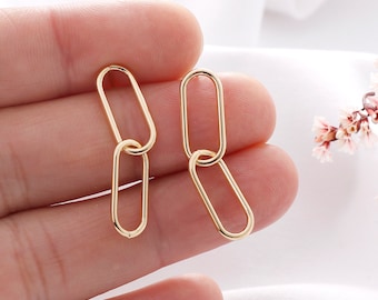 May include: A pair of gold-toned chain link earrings. Each earring features two oval-shaped links.