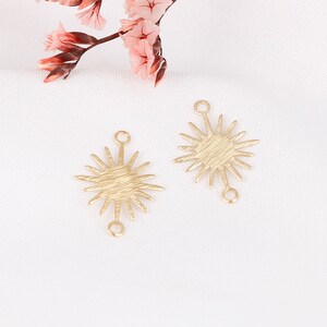 May include: Two gold-toned metal starburst charms with a textured finish. Each charm has two jump rings for attaching to jewelry.
