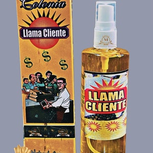 May include: A yellow and gold bottle of cologne with a white spray nozzle. The bottle has a label that says "Llama Cliente" and "Colonia" in a vintage style font. The bottle is 3.3 fluid ounces or 100 milliliters.