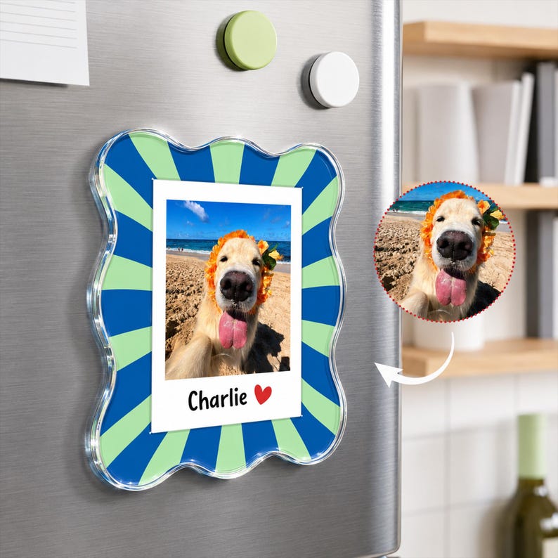 May include: A wavy-edged rectangular acrylic magnet featuring a blue and light green sunburst pattern. The center displays a white rectangular insert with a photograph of a golden retriever wearing a flower crown, with the text Charlie and a red heart.