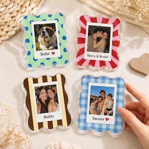 May include: Four wavy-edged acrylic photo frames featuring custom prints: a green frame with blue dots labeled Butter, a red and pink striped frame labeled Henry & Krystal, a brown and tan striped frame labeled Besties, and a blue gingham frame labeled Forever.