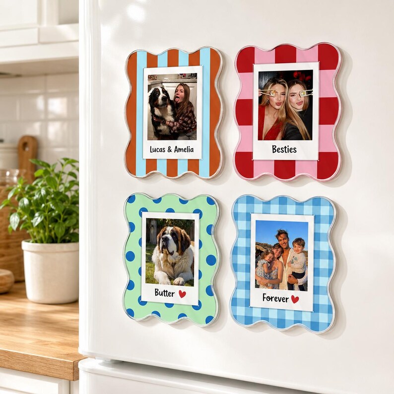 May include: Four rectangular magnetic photo frames with wavy edges. The top left frame has blue and orange vertical stripes with the text Lucas & Amelia. The top right frame has red and pink blocks with the text Besties. The bottom left frame has green and blue polka dots with the text Butter and a heart. The bottom right frame has blue and white gingham with the text Forever and a heart.