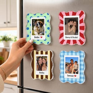 May include: Four rectangular magnetic photo frames with wavy edges. The top left frame is light green with blue dots and the text Butter. The top right is red and white striped with the text Henry & Krystal. The bottom left is brown and tan striped with the text Besties. The bottom right is blue checkered with the text Forever.