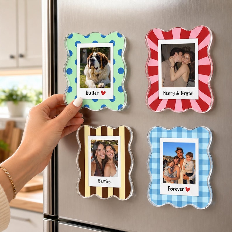 May include: Four rectangular magnetic photo frames with wavy edges. The top left frame is light green with blue dots and the text Butter. The top right is red and white striped with the text Henry & Krystal. The bottom left is brown and tan striped with the text Besties. The bottom right is blue checkered with the text Forever.