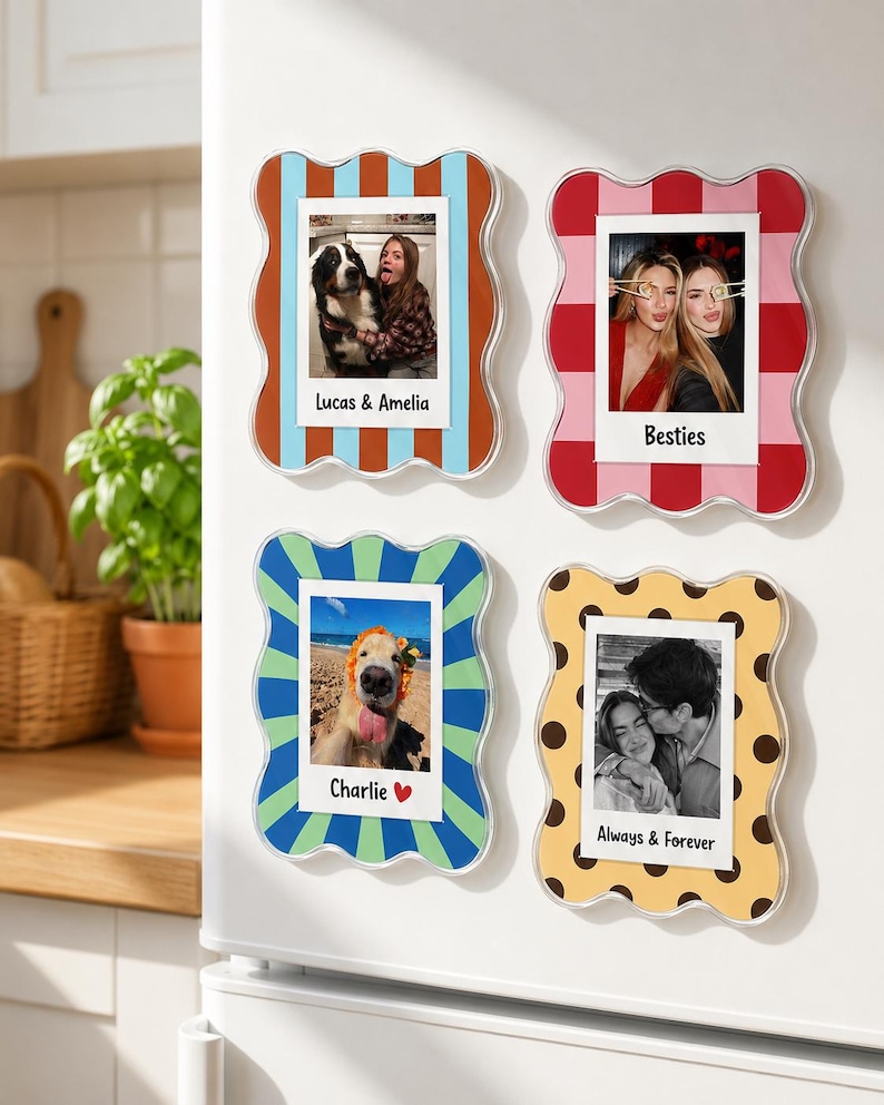 May include: Four rectangular magnetic photo frames with wavy edges. The top left frame has blue and orange stripes with the text Lucas & Amelia. The top right frame has red and pink checks with the text Besties. The bottom left has blue and green stripes with the text Charlie. The bottom right has yellow with brown dots and the text Always & Forever.