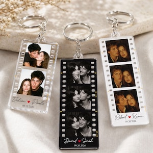 May include: Three rectangular keychains designed like film strips, each featuring two or three portrait photos of couples. The keychains include silver metal rings and chains. Printed text includes names like Julian and Paula, David and Sarah, or Robert and Karen, along with dates such as 09.12.2026 or 09.20.2026.