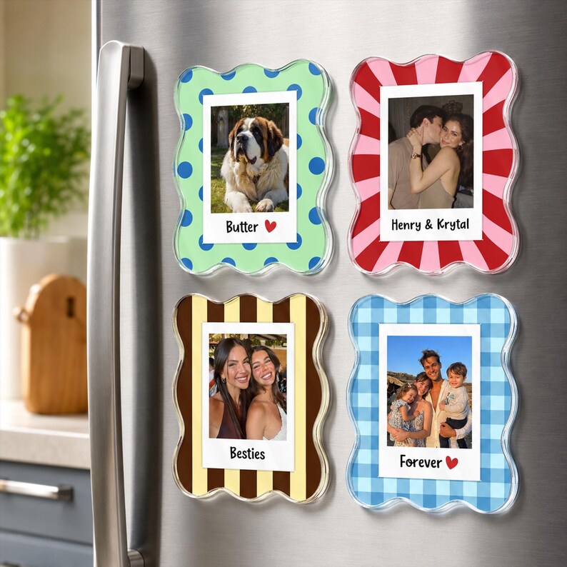 May include: Four rectangular magnetic photo frames with wavy edges. Top left: light green with blue dots, photo of a dog, text "Butter". Top right: red and pink stripes, photo of a couple, text "Henry & Krystal". Bottom left: brown stripes, photo of two people, text "Besties". Bottom right: blue gingham, photo of a family, text "Forever".