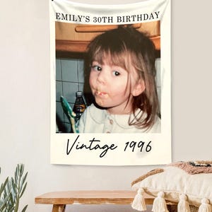 May include: A wall tapestry featuring a vintage photo of a young girl with the text "EMILY'S 30TH BIRTHDAY" and "Vintage 1996". The photo is framed in a white border, creating a nostalgic aesthetic.