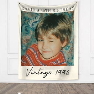 May include: A wall tapestry featuring a vintage photo of a young boy winking, wearing a red and white striped shirt. The text "DAVID'S 30TH BIRTHDAY" is at the top, with "Vintage 1996" at the bottom.