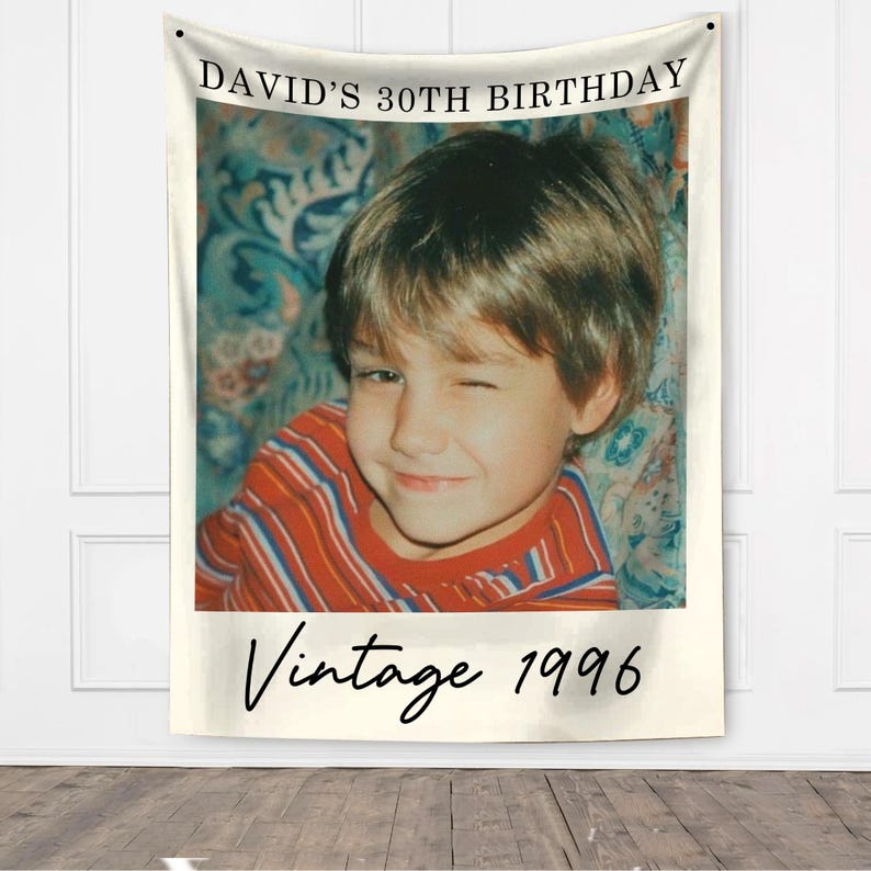 May include: A wall tapestry featuring a vintage photo of a young boy winking, wearing a red and white striped shirt. The text "DAVID'S 30TH BIRTHDAY" is at the top, with "Vintage 1996" at the bottom.