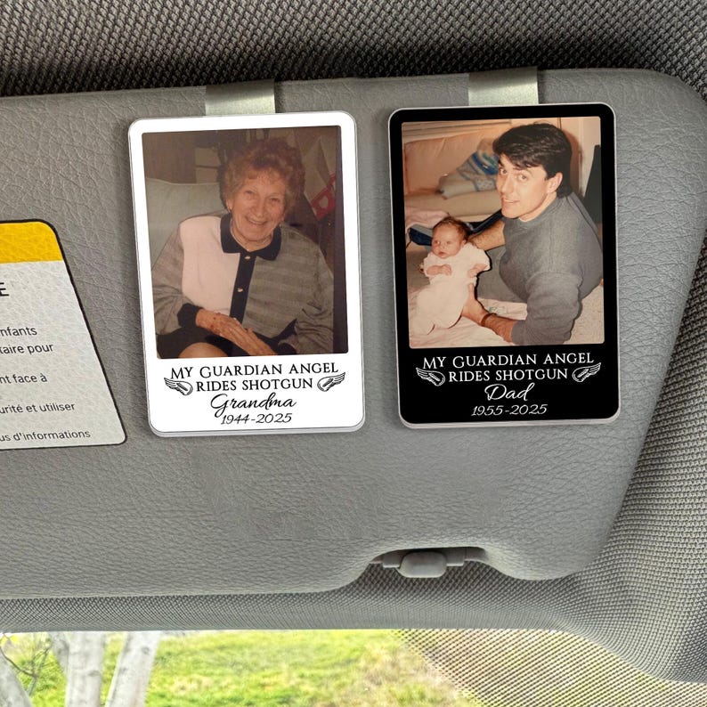 May include: Two rectangular car visor clips with photos and text. One features a photo of a woman with the text "MY GUARDIAN ANGEL RIDES SHOTGUN Grandma 1944-2025". The other shows a man holding a baby, with the text "MY GUARDIAN ANGEL RIDES SHOTGUN Dad 1955-2025".