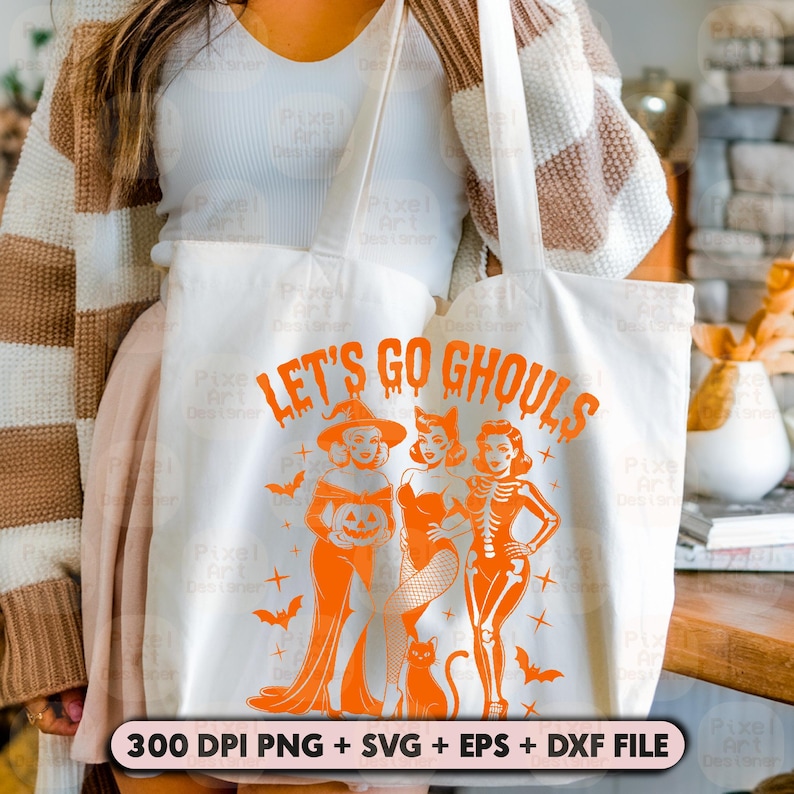 May include: Cream-coloured tote bag printed with the words "LET'S GO GHOULS" in orange, and illustrations of Halloween figures, a black cat, and bats. The bag also includes the text "300 DPI PNG + SVG + EPS + DXF FILE".