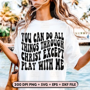 May include: A white t-shirt with black text that reads "You can do all things through Christ except play with me". The text is in a retro, groovy font style.